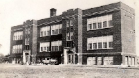 Gillett High School.  Sports Car in front.